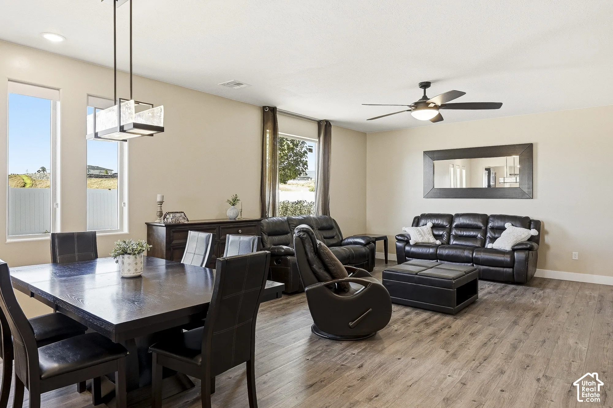 Open-concept living area featuring wood-finish flooring, recessed lighting, and a ceiling fan