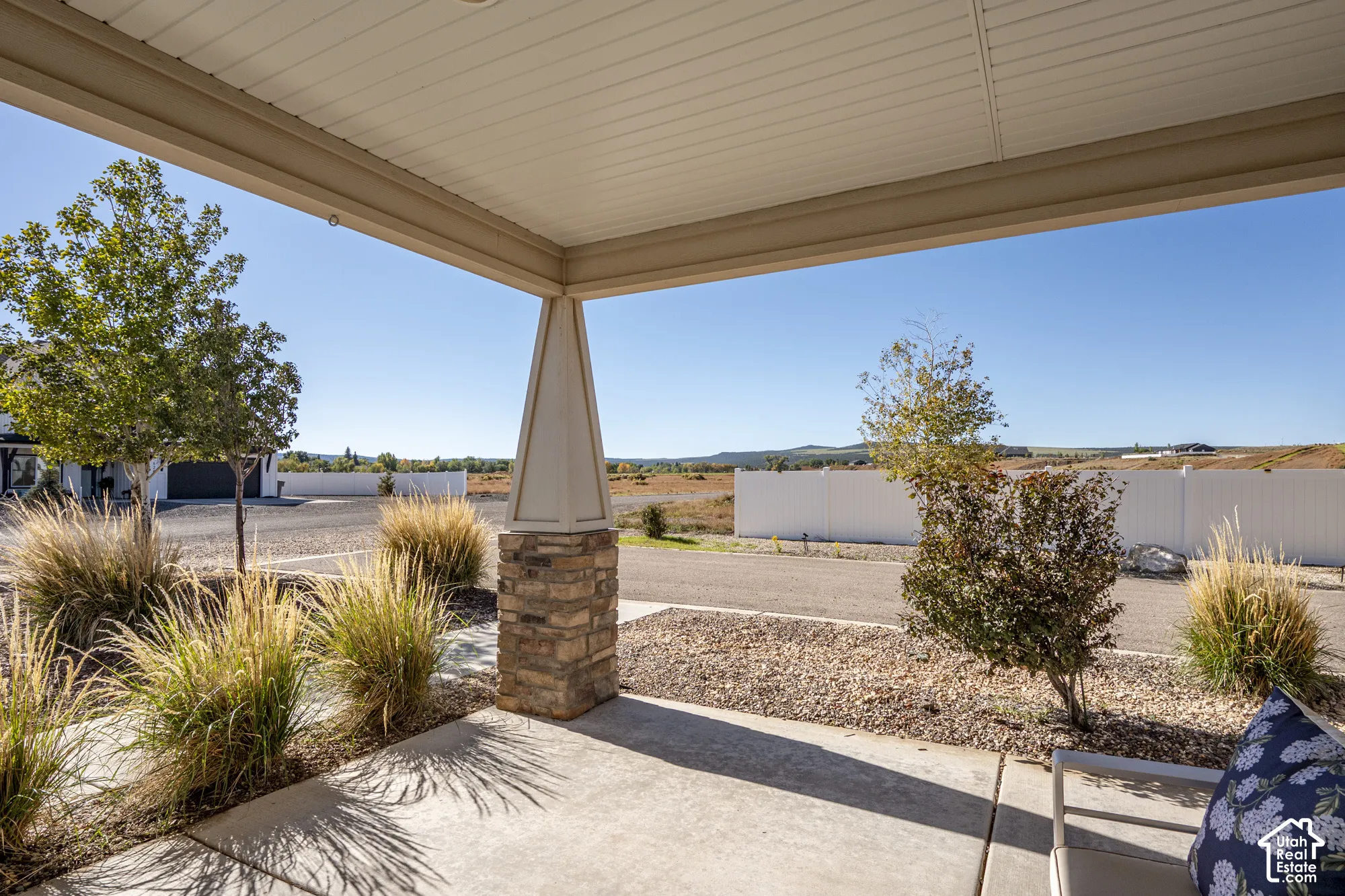 Covered concrete patio with a stone-accented column