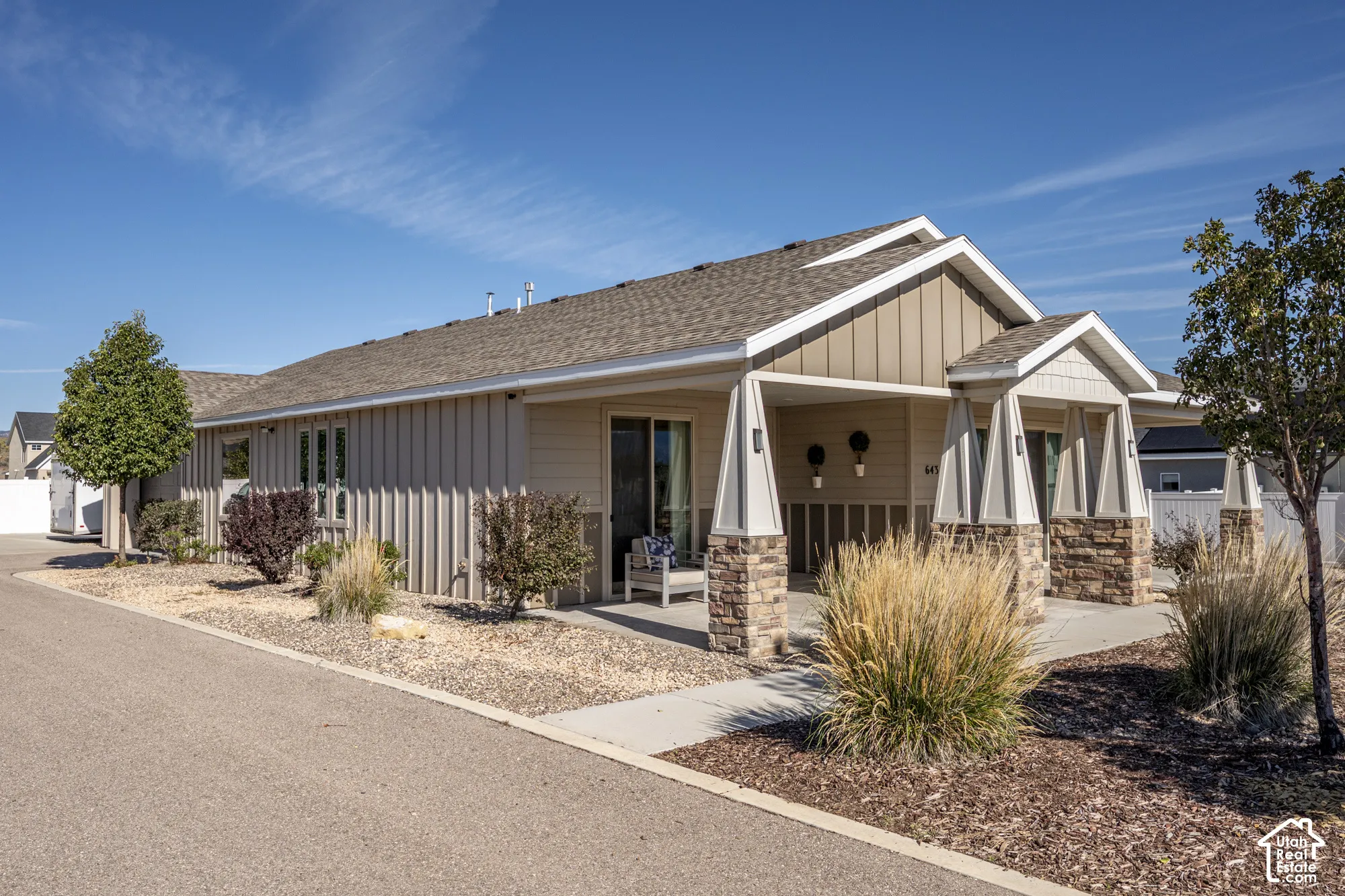 Siding exterior with stone accents and a covered entry