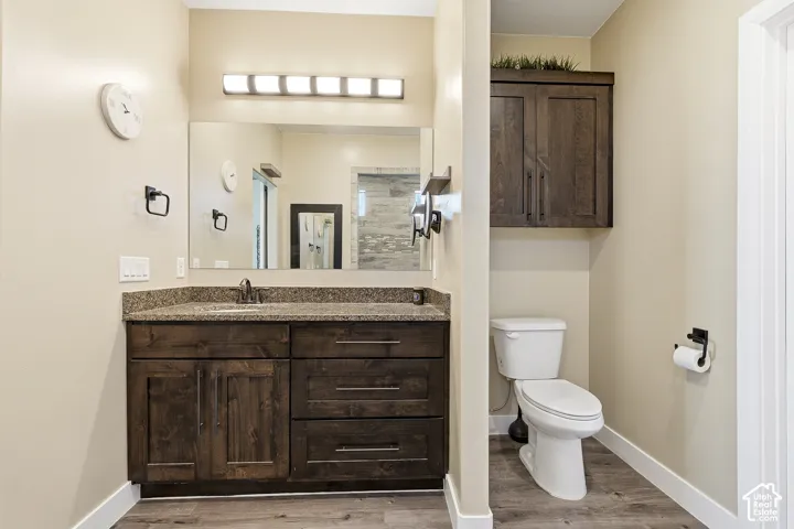 Rich wood-finish vanity with an integrated sink and granite-style countertop