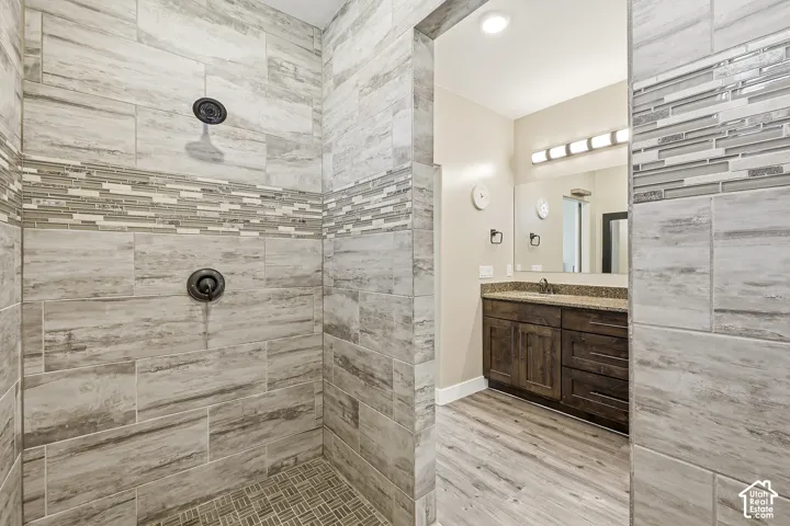 Walk-in shower with large format tile and mosaic accent band