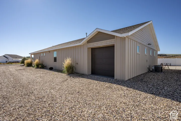 Attached two-car garage with a dark brown overhead door