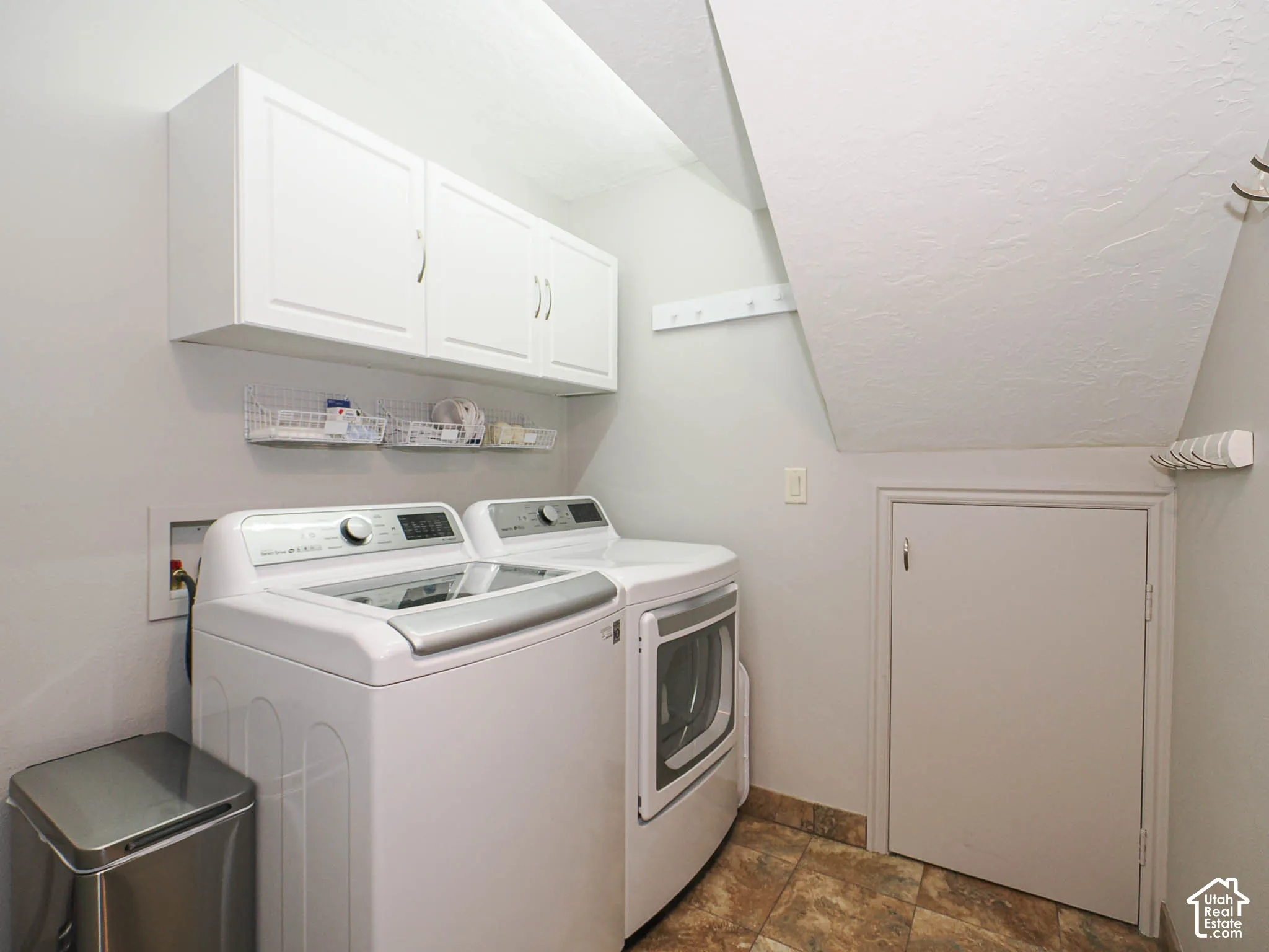 White cabinetry, tiled flooring, and a built-in wire shelf