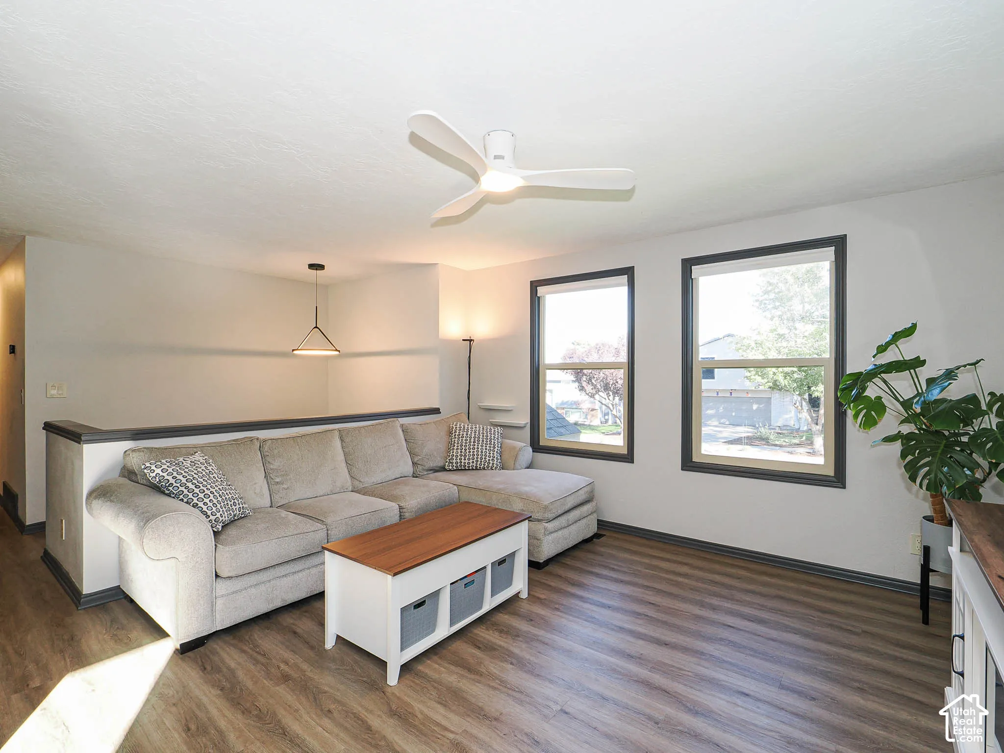 Wood-finish flooring with dual windows featuring dark trim
