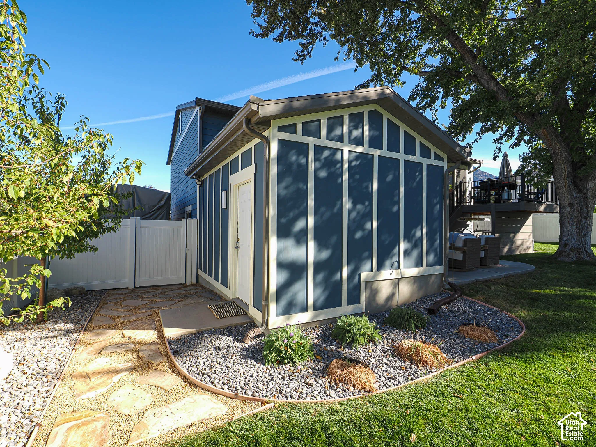 Detached outbuilding with vertical siding and trim details