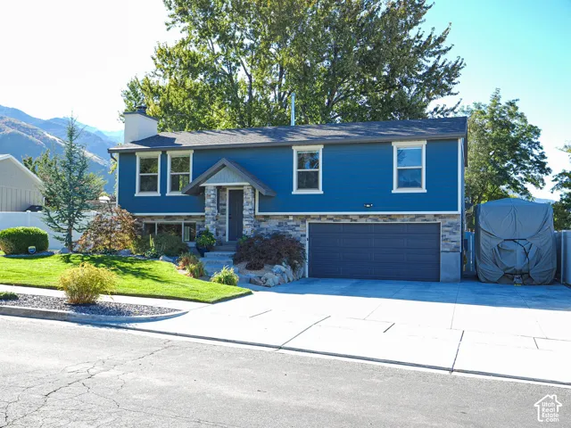 Striking blue two-story home featuring a clean front fa