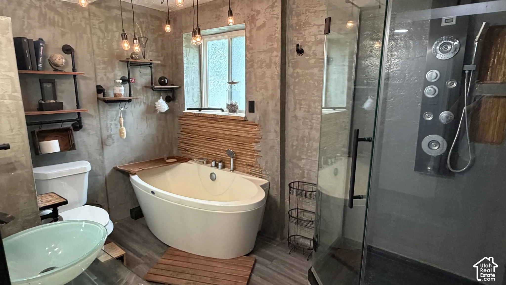Bathroom 3 - Freestanding soaking tub, glass-enclosed shower with multiple spray settings, vessel sink and built-in industrial-style shelving