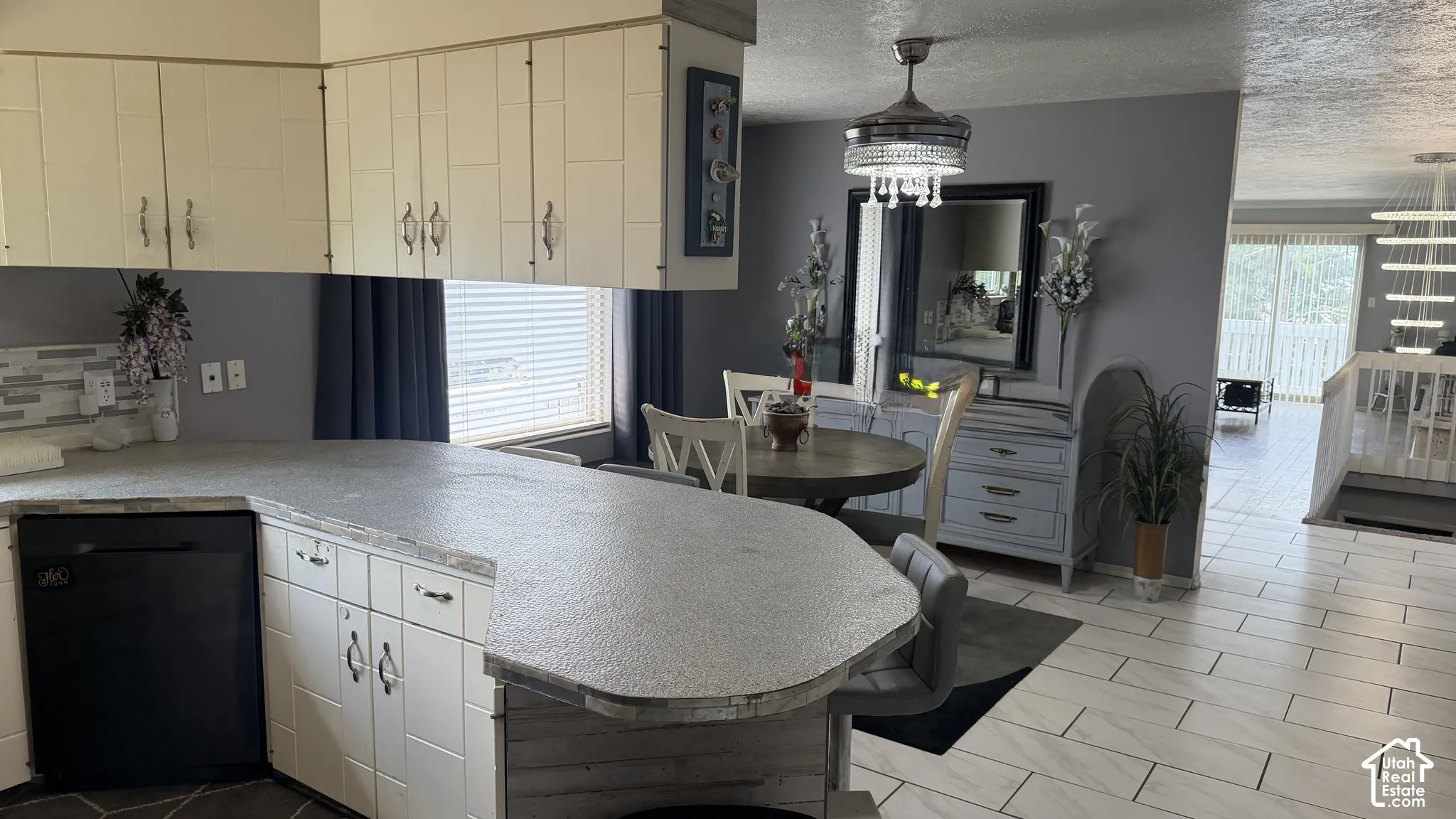 Spacious kitchen featuring a large center island, dining area and tile flooring