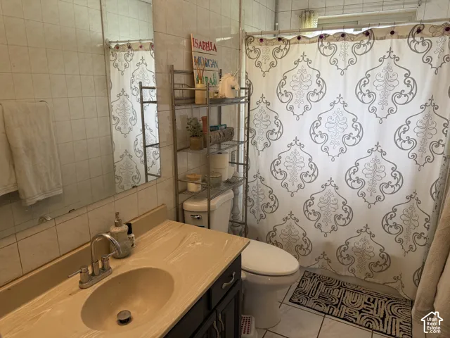 Bathroom 2-  wood-finish vanity cabinetry, bathtub and tile flooring