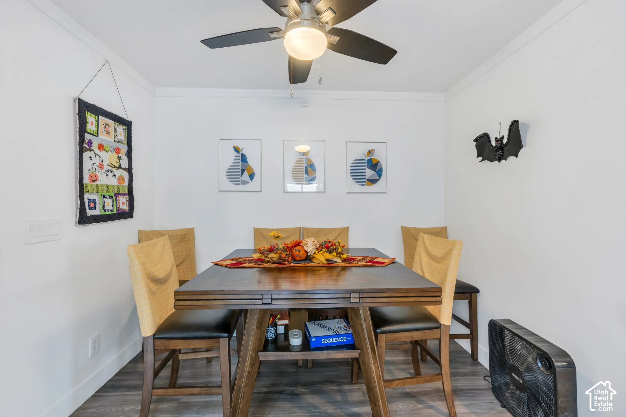 Wood-finish flooring, white walls, and crown molding