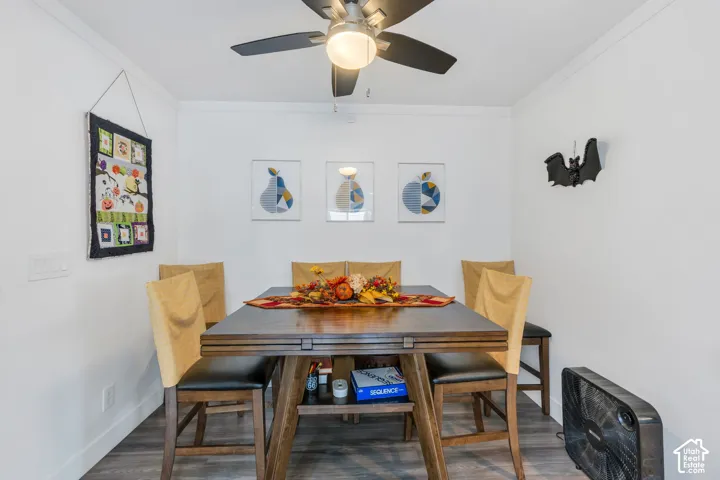 Wood-finish flooring, white walls, and crown molding
