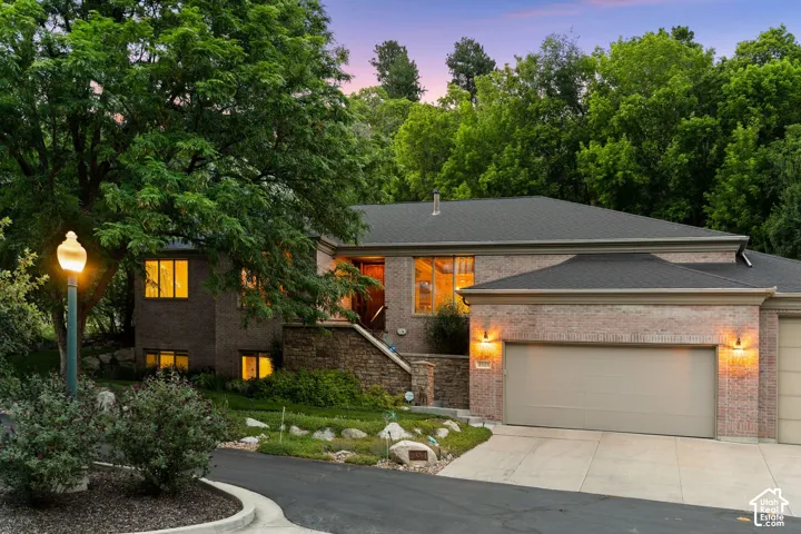 Brick exterior with dark roof and attached two-car garage