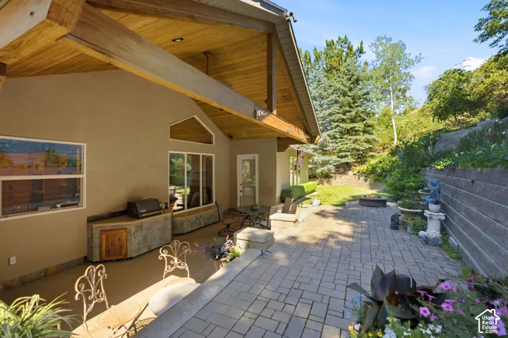 Expansive outdoor patio with pavers and a built-in outdoor kitchen