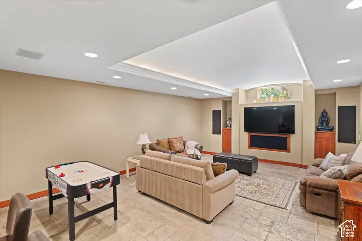 Recessed lighting, tile flooring, built-in cabinetry, tray ceiling with cove lighting, and integrated wall speakers