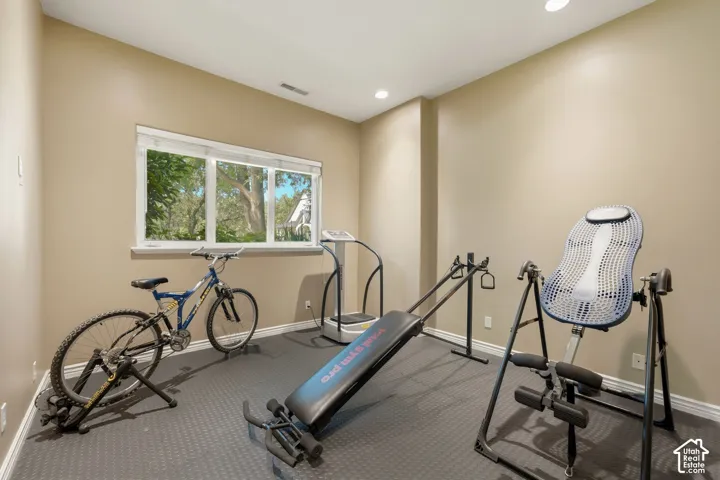 Recessed lighting, neutral wall tones, large window, and durable flooring