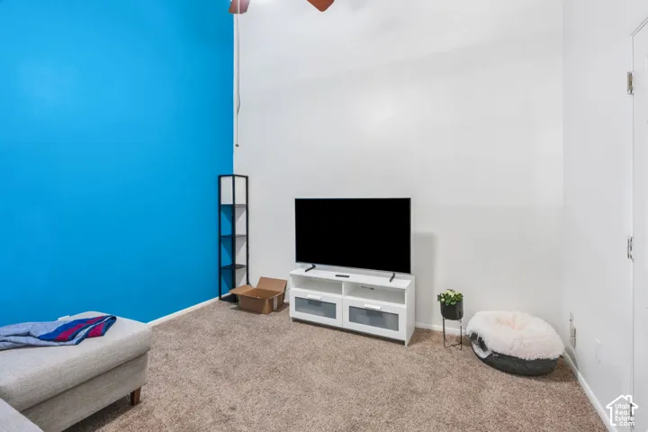 Carpeted flooring, vaulted ceiling, and a ceiling fan