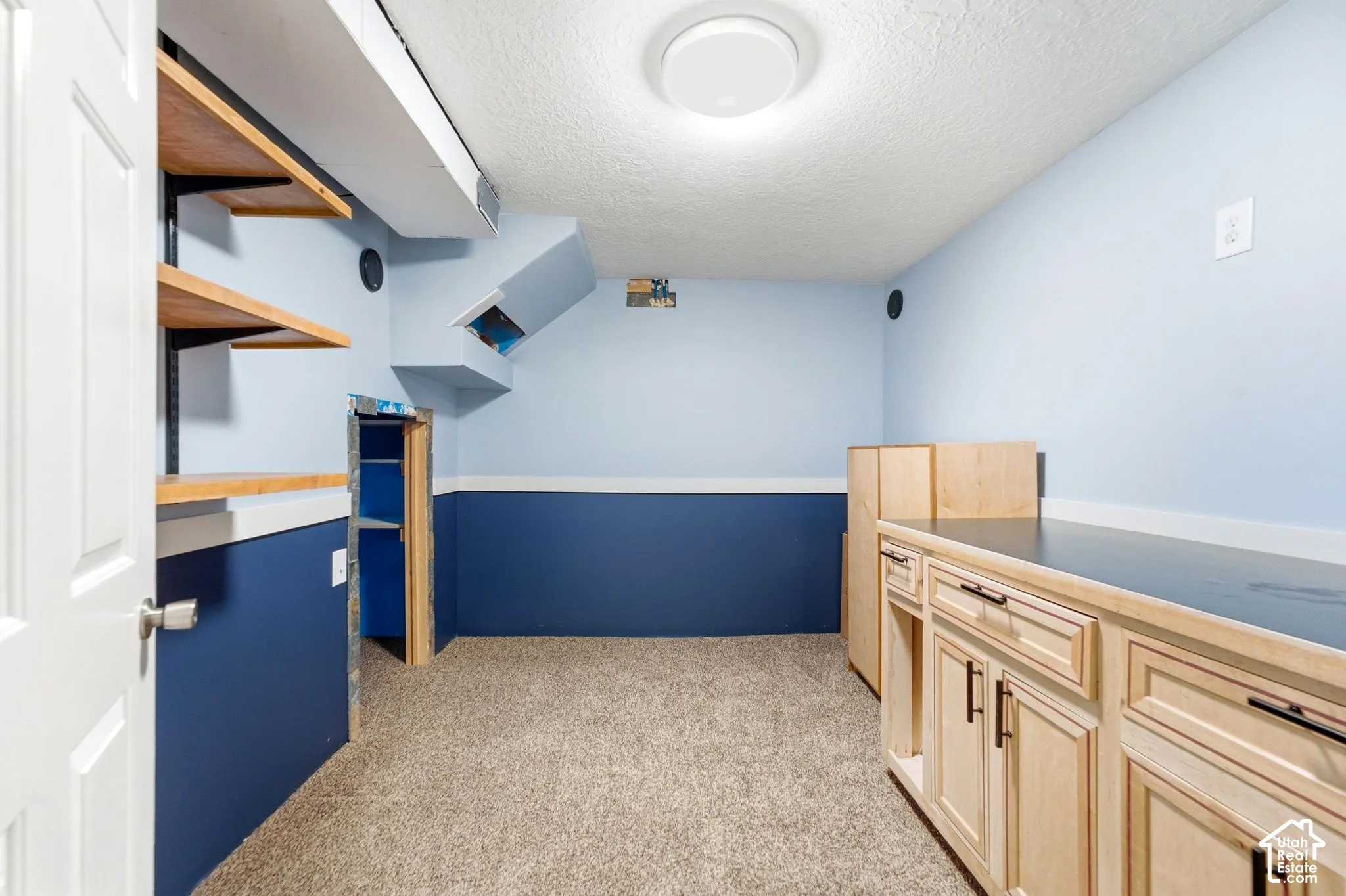 Built-in cabinetry with dark hardware and a contrasting countertop