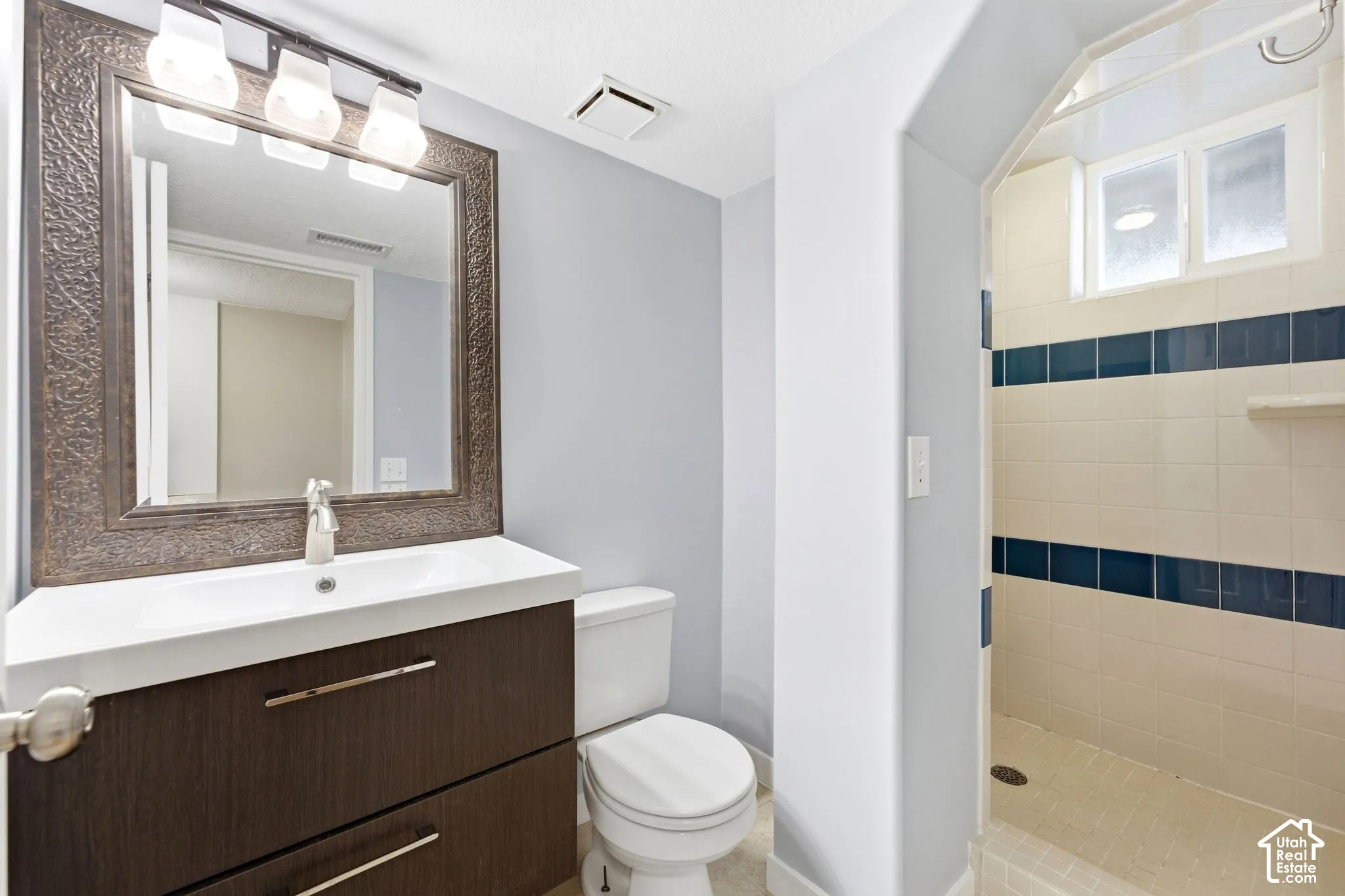 Vanity with an integrated sink and wood-finish cabinetry