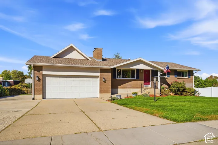 Brick exterior with a gabled roof and attached garage