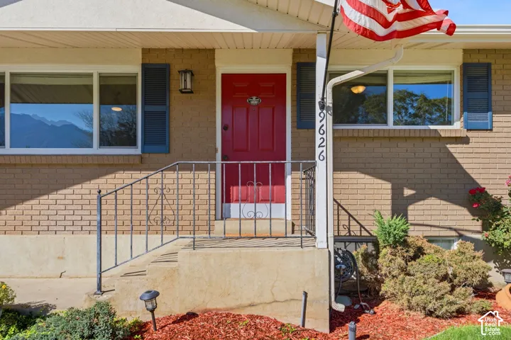 Brick exterior with a red entry door