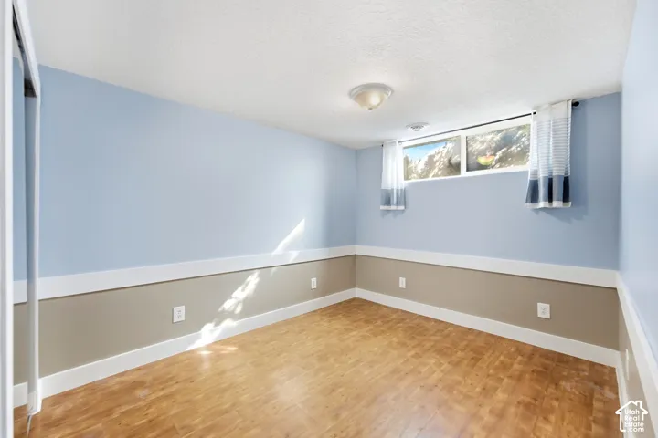 Wood-finish flooring, two-tone wall treatment, and an egress window