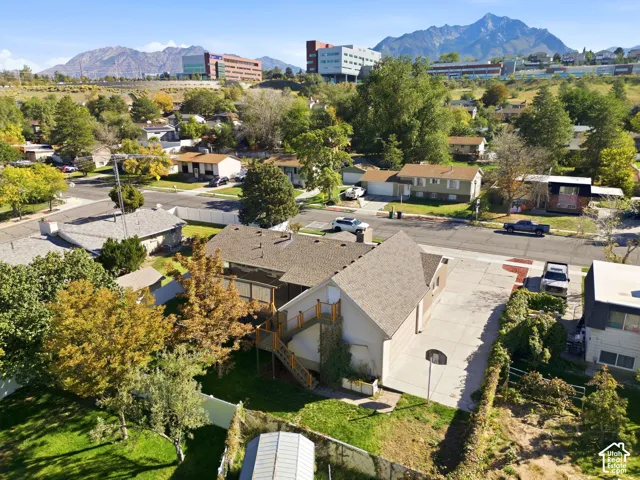 Property featuring a paved driveway, attached garage, and a multi-level deck