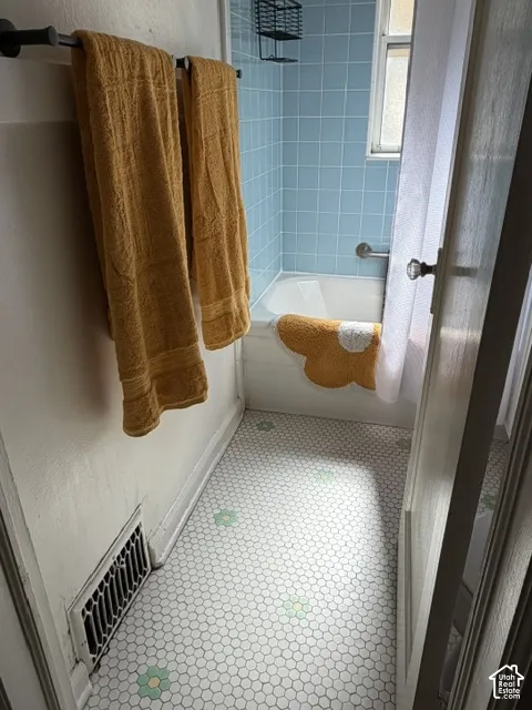 White hexagon tile flooring with green and yellow accents