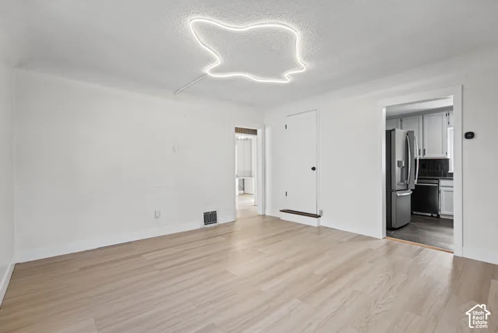 White walls with light wood-finish flooring