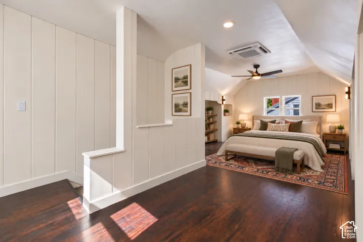 Wood-finish flooring throughout, board and batten wall finishes, recessed lighting, ceiling-mounted fan, and wall sconces