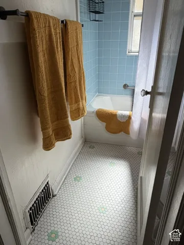 White hexagon tile flooring with green and yellow accents