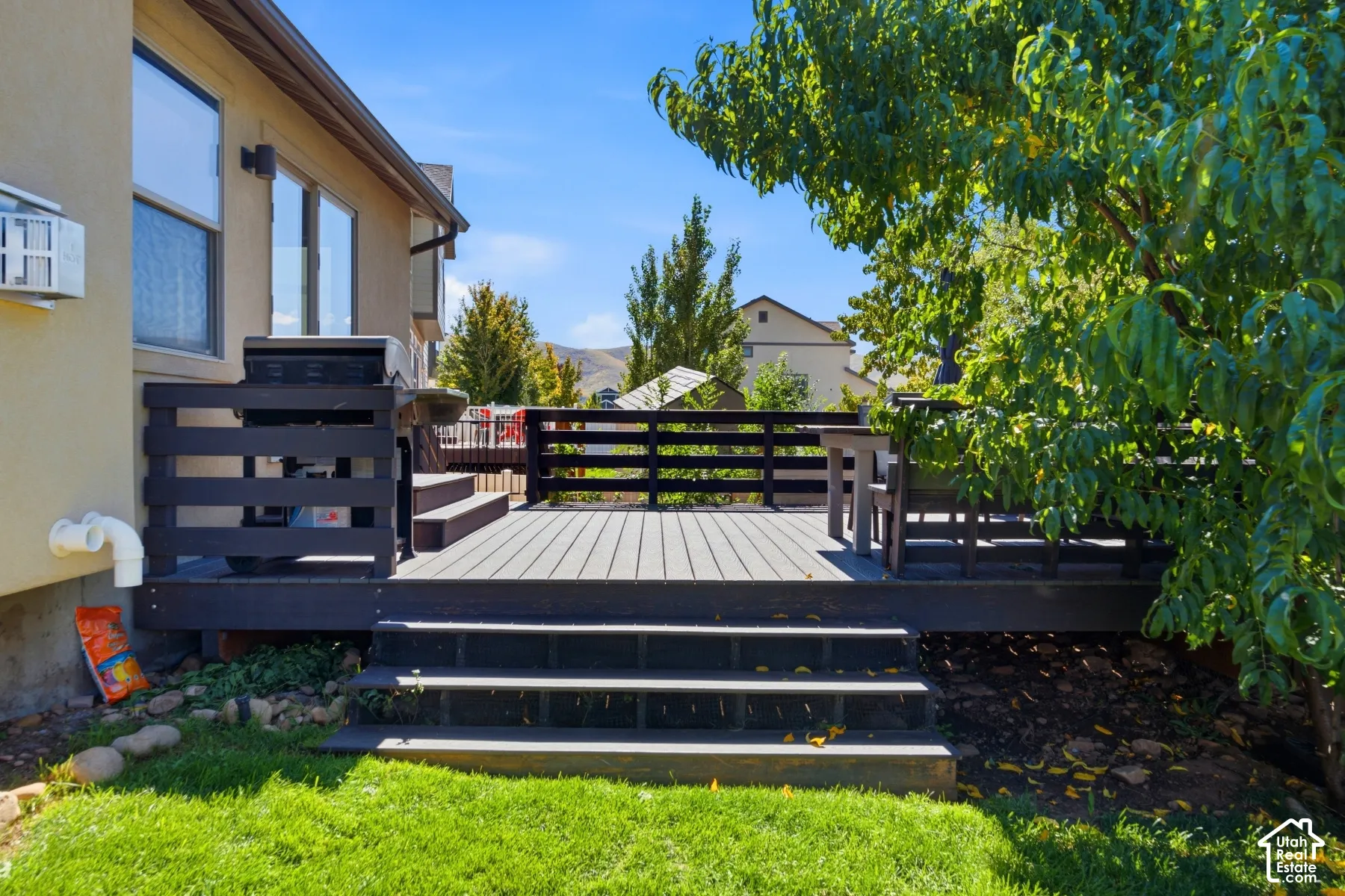 Expansive outdoor decking with multi-level access and dark wood-finish railings