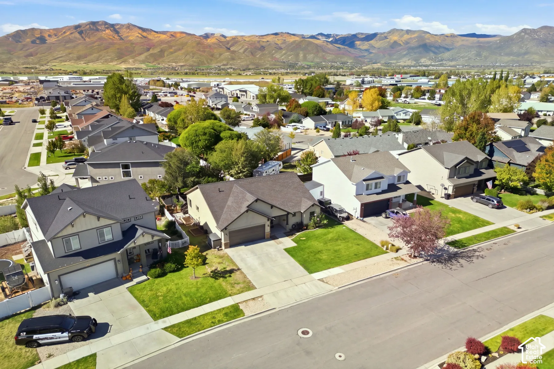 Residential neighborhood with established homes, paved streets, and a mountain backdrop