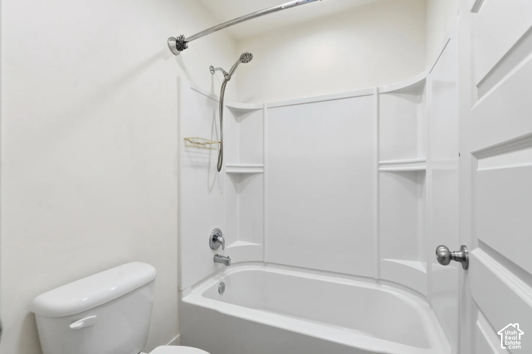 White tub and shower combination with a curved shower rod and brushed nickel fixtures