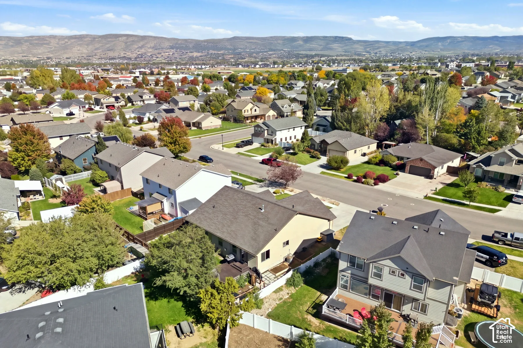 Established neighborhood setting featuring mature trees and distant mountain scenery