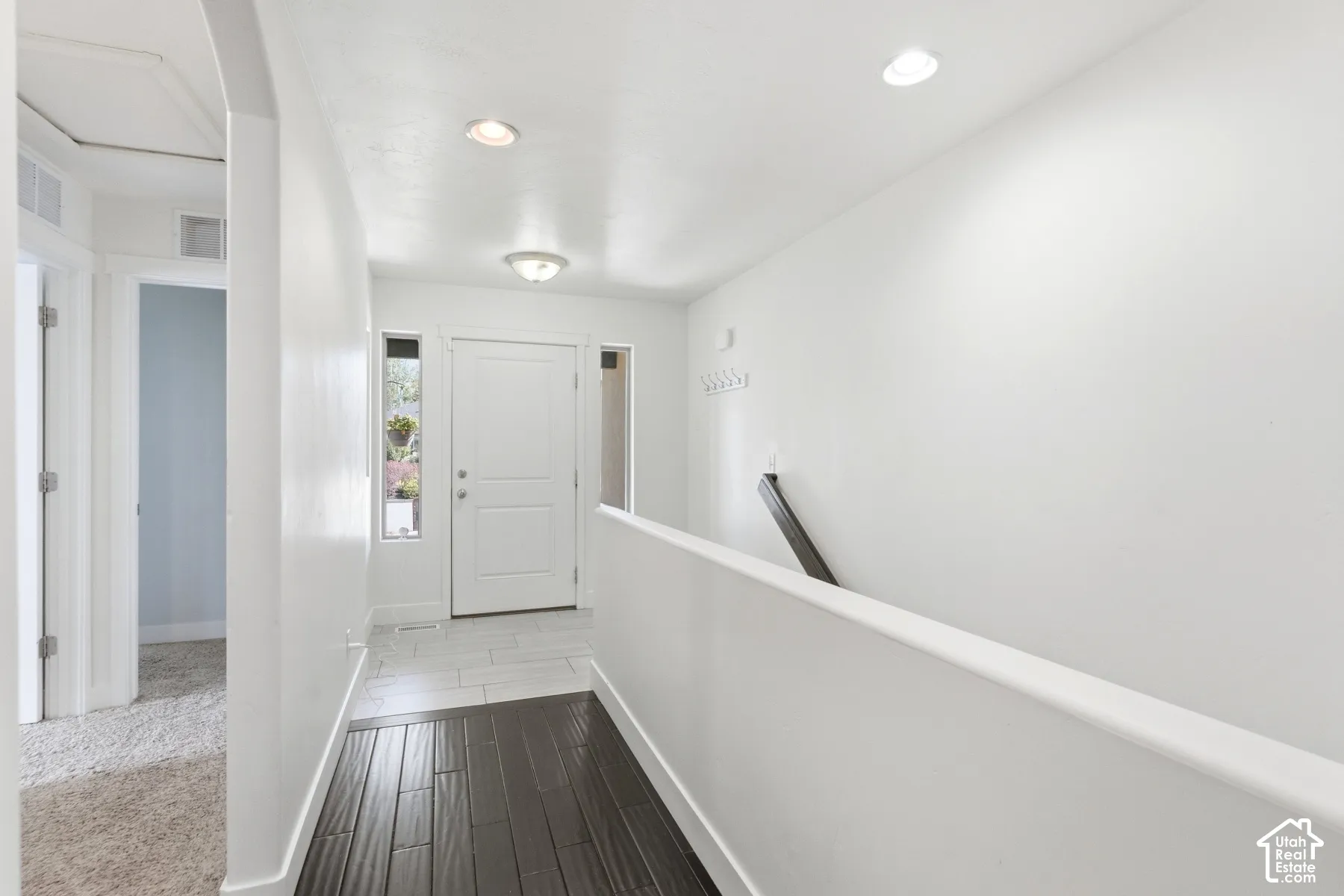 Entryway featuring a white paneled door, sidelight windows, recessed lighting, and a flush mount light fixture