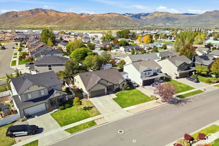 Residential neighborhood with established homes, paved streets, and a mountain backdrop