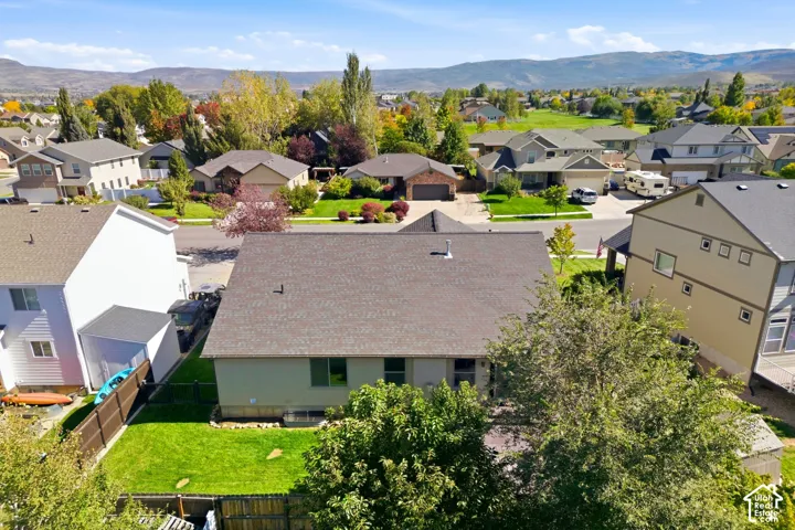 Charming single-story residence showcasing a spacious, manicured lawn with mature landscaping and established trees