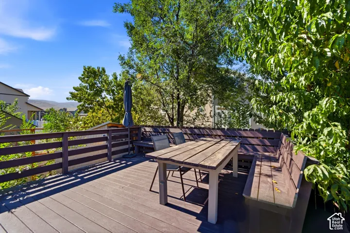 Expansive outdoor deck with composite decking, dark wood railings, and built-in bench seating