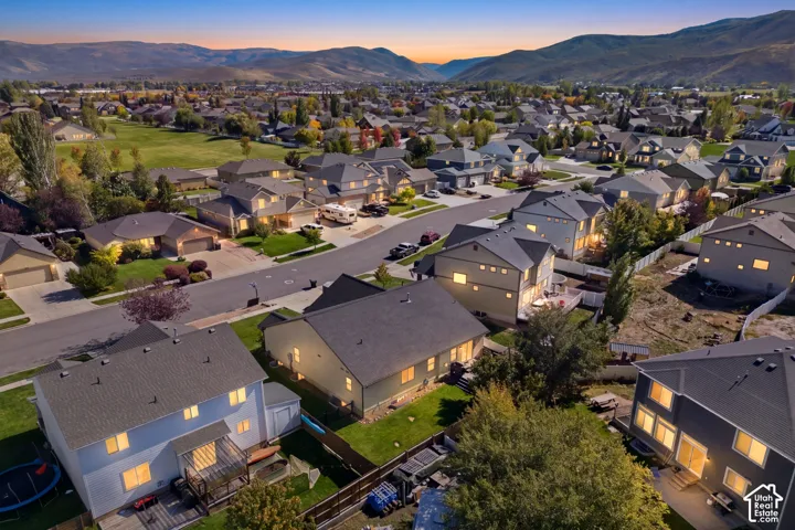 Residential neighborhood with varied architectural styles and a mountain backdrop