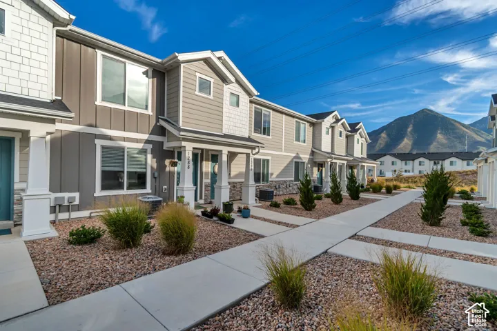 Contemporary townhome exterior with mixed siding and stone accents