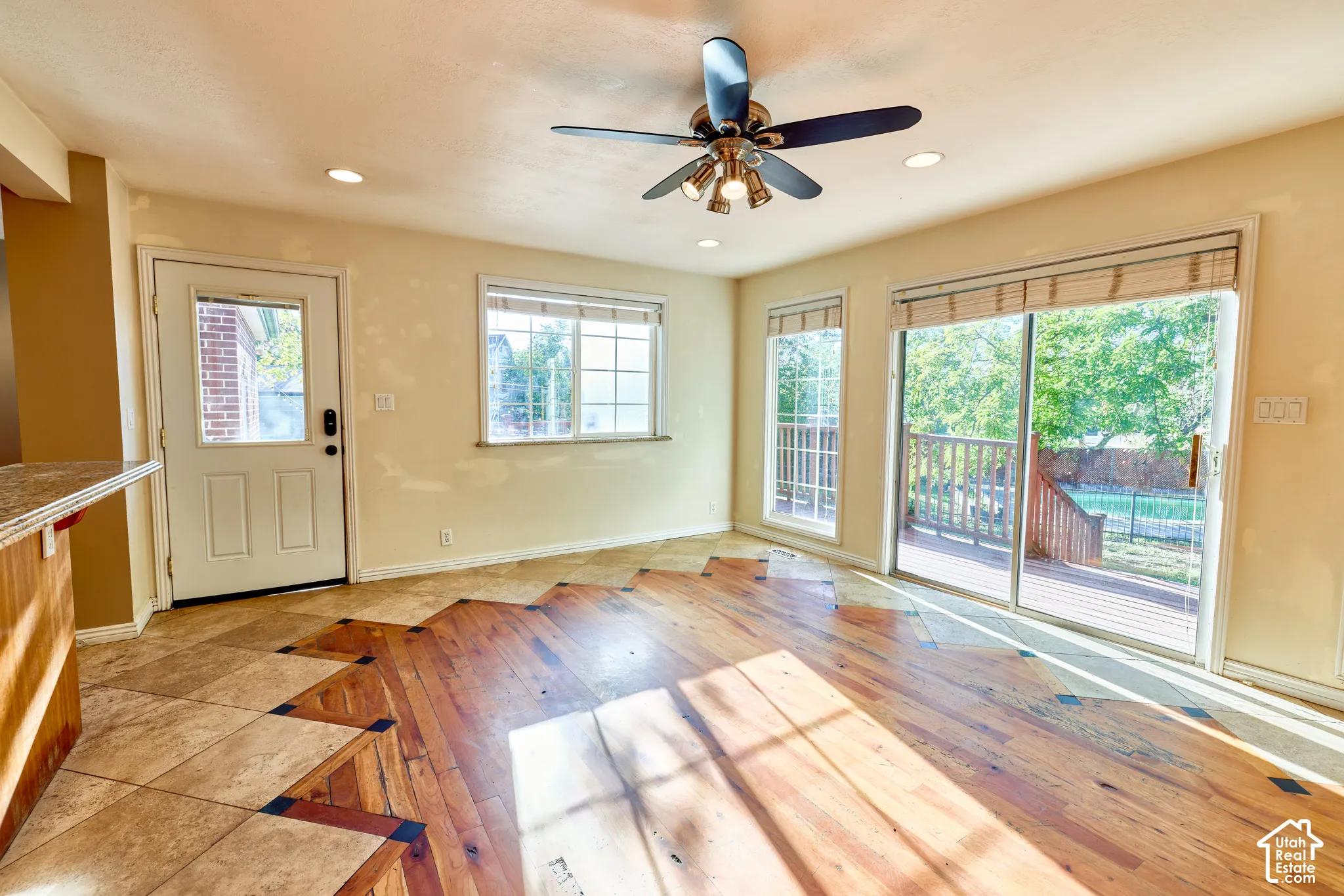 Recessed lighting, ceiling fan, wood-finish flooring, sliding glass door, and backyard deck