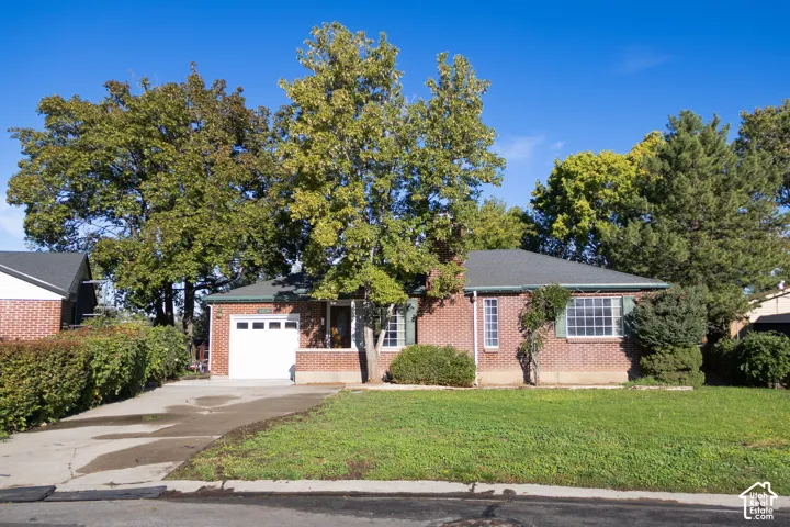 Brick exterior with a gabled roof and attached garage