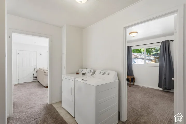Laundry area with tile flooring and built-in cabinetry