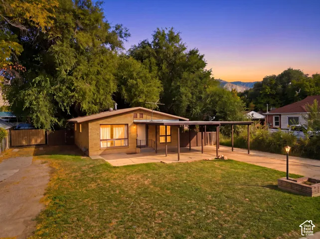 Brick exterior with a covered carport