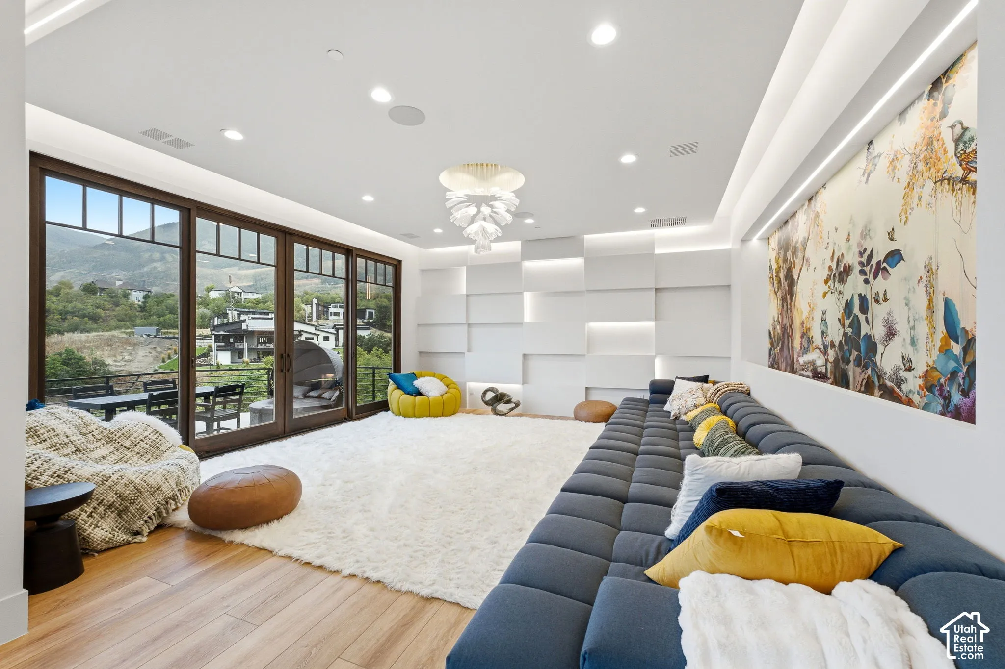 Wide plank wood-finish flooring with a large area rug