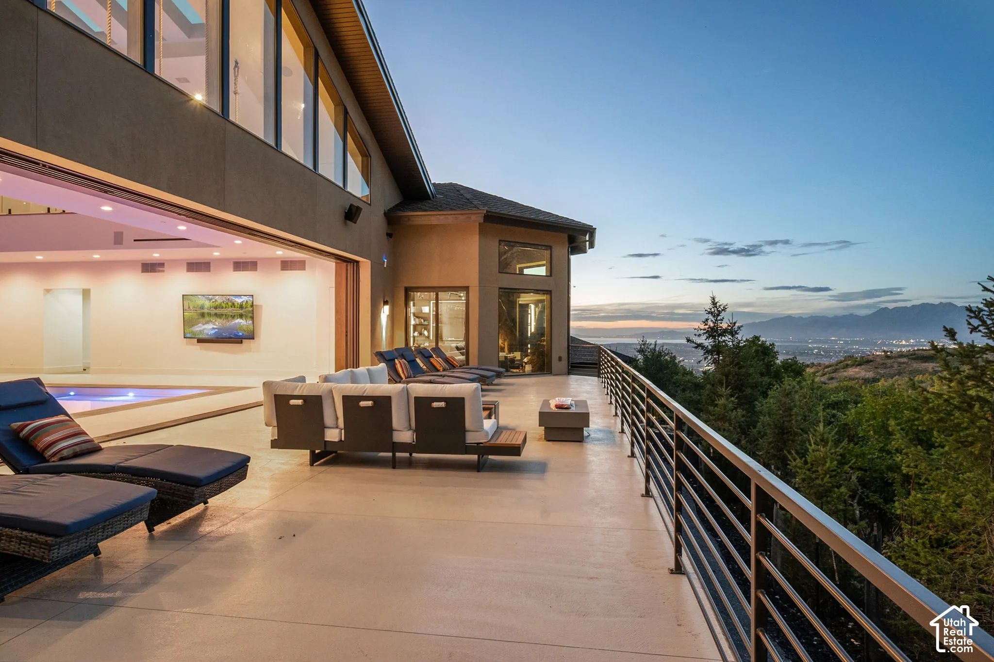 Expansive outdoor deck with a metal railing and mountain scenery