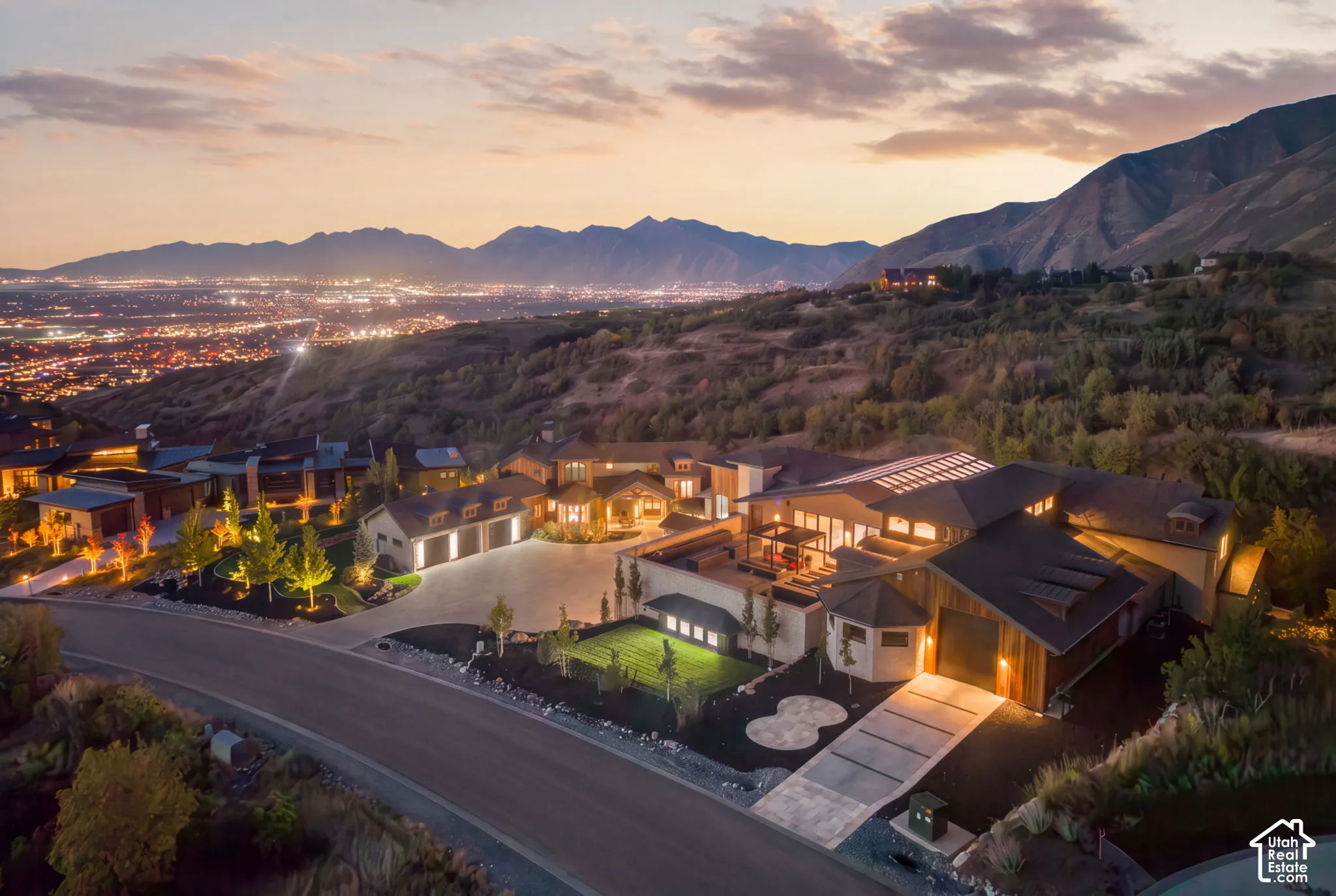 Expansive property featuring multiple structures, a multi-car garage, and a structured driveway
