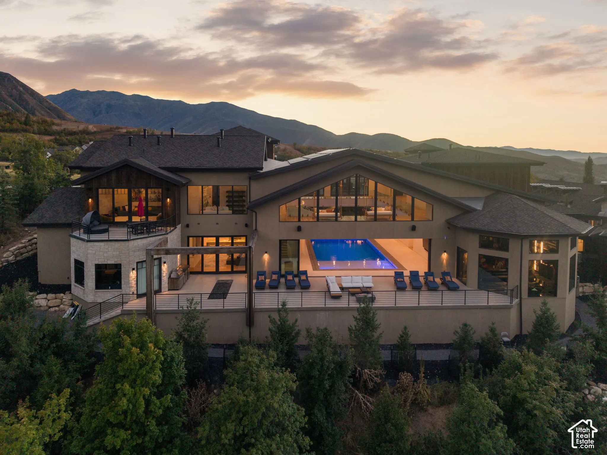 Expansive exterior featuring a large deck, an integrated swimming pool, multiple large windows, and a multi-level design