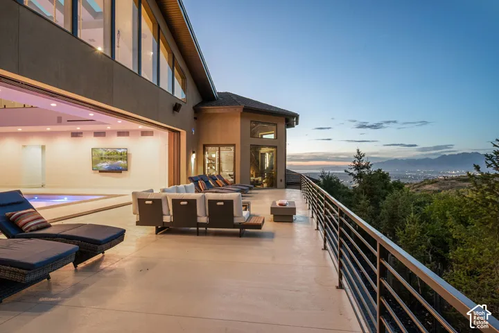 Expansive outdoor deck with a metal railing and mountain scenery