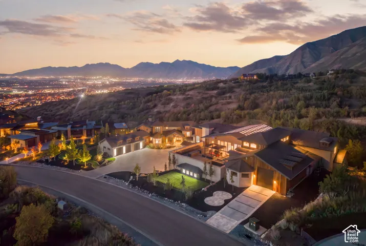 Expansive property featuring multiple structures, a multi-car garage, and a structured driveway